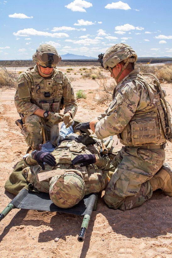 Soldiers assess a mock patient during a casualty evacuation exercise.