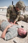 A 379th Air Expeditionary Security Forces Squadron Airman provides medical care to a simulated hostage during an attack notification response exercise at Al Udeid Air Base, Qatar, March 22, 2018. The scenario, commenced in a realistic and unanticipated manner, was designed to improve physical and procedural security as well as warning and alert notification capabilities. (U.S. Air Force photo by Staff Sgt. Joshua Horton)