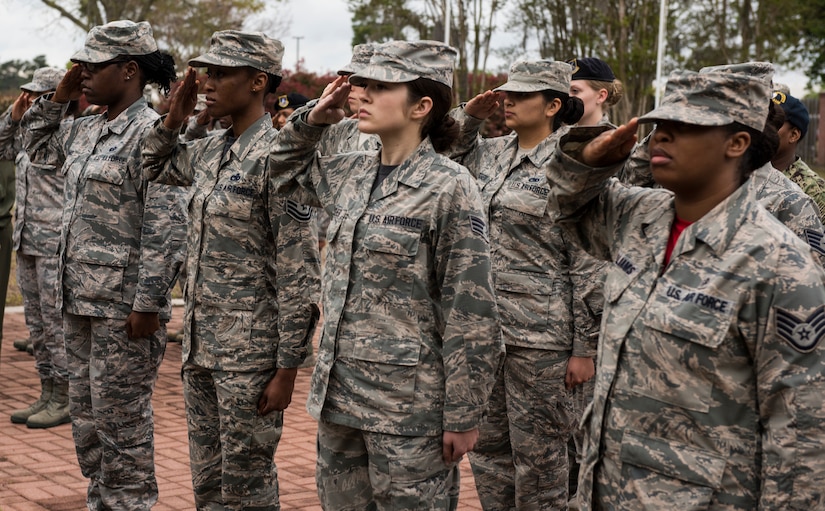 Airmen salute the U.S. flag during a retreat ceremony March 30, 2018, at Joint Base Charleston, S.C.