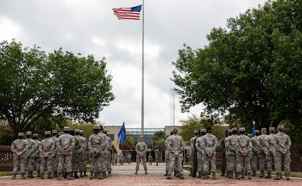 Airmen stand in formation during a retreat ceremony March 30, 2018, at Joint Base Charleston, S.C.