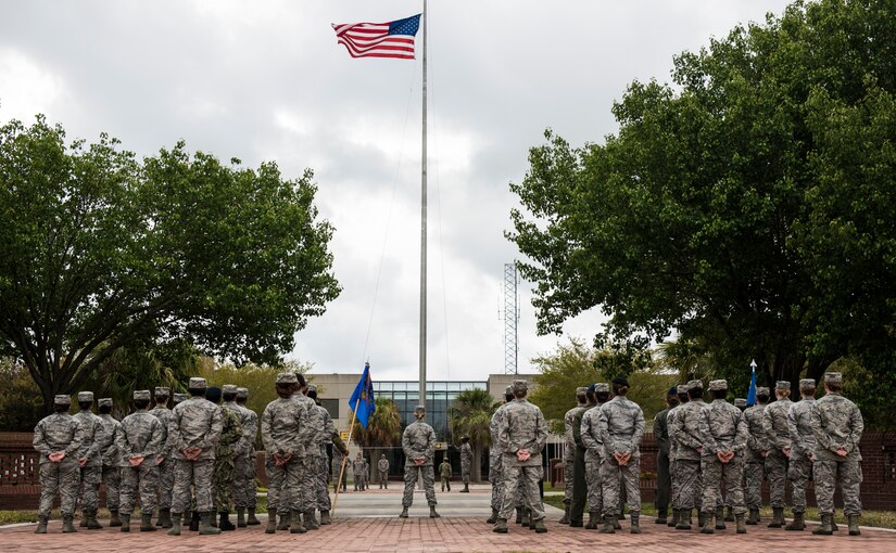 Airmen stand in formation during a retreat ceremony March 30, 2018, at Joint Base Charleston, S.C.