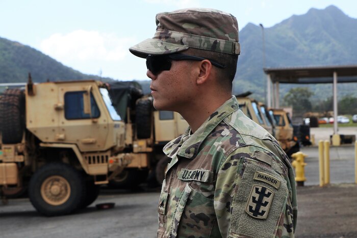A soldier stands wearing his new Ranger tab on his uniform.
