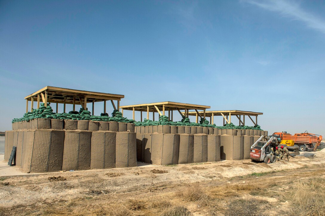 Soldiers construct a munitions storage bunker.