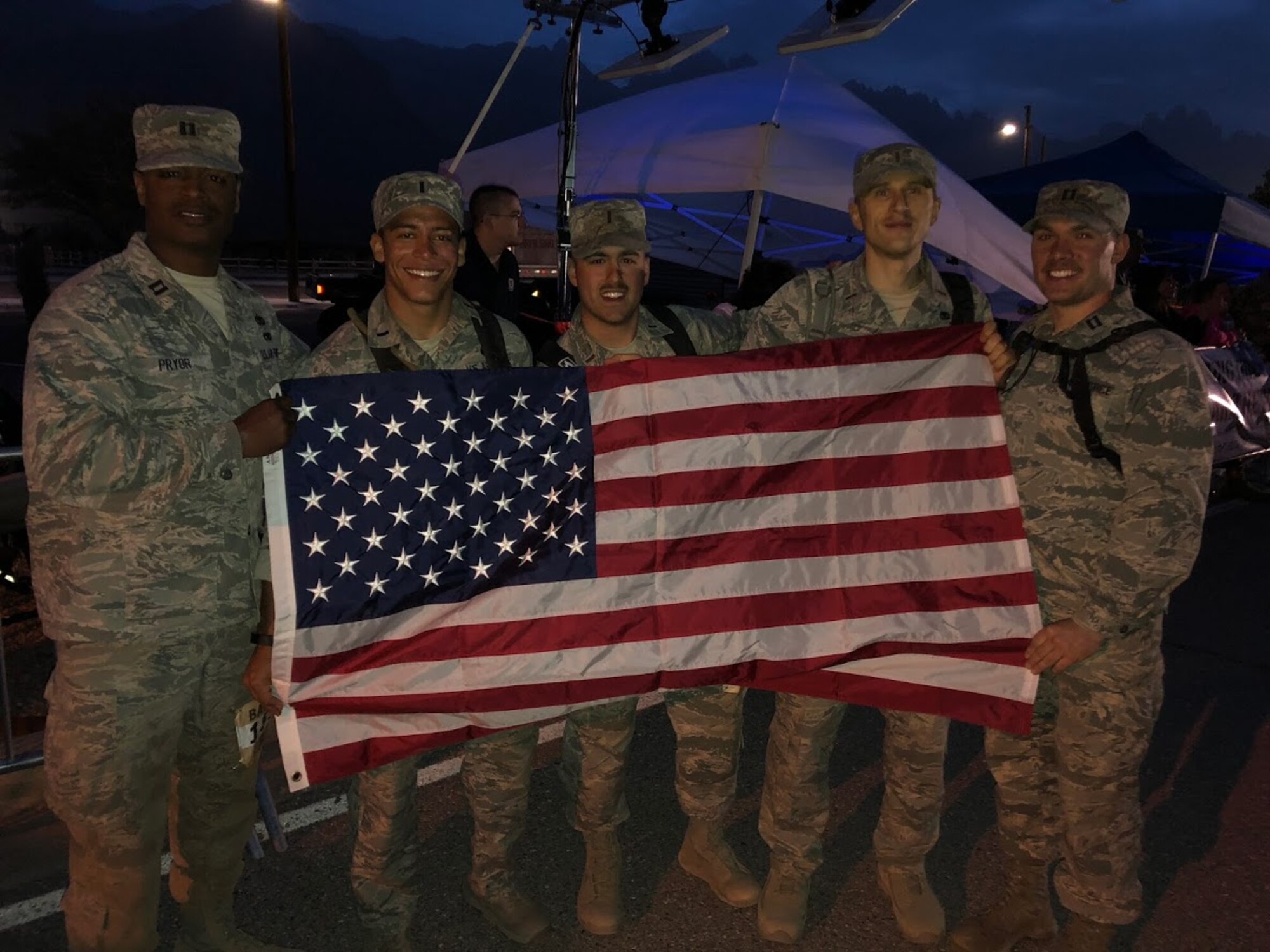 A team from Altus Air Force Base, Okla. holds up the American Flag after making it to the finish line of the 29th annual Bataan Memorial Death March, March 25, 2018, at White Sands, N.M.