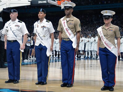 The 2018 Joint Base San Antonio Ambassadors prepare to take part in pregame ceremonies at NCAA Division I men's basketball championship game at the Alamodome Monday, April 2, 2018. From left to right are: Army Sgt. 1st Class Nicholas J. Warner; Army Sgt. 1st Class Latrise N. Flanigan, Marine Sgt. Jonaton T. McFadden and Marine Cpl. Emanuela Shehu.