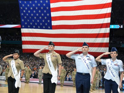 Members of the 2018 Joint Base San Antonio Ambassadors salute during the National Anthem as part of the pregame ceremonies at the NCAA Division I men's basketball championship game at the Alamodome Monday, April 2, 2018. From left are Petty Officer 2nd Class Diana Mendoza Se Saenz, Petty Officer 1st Class Shannon Chatterton, Tech. Sgt. Christofer Mercado and Tech. Sgt. Melissa Bennett.