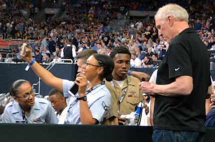 Legendary NBA player Bill Walton (right) signs autographs for military members and poses for selfies during the at the NCAA Division I men's basketball championship game at the Alamodome Monday, April 2, 2018.