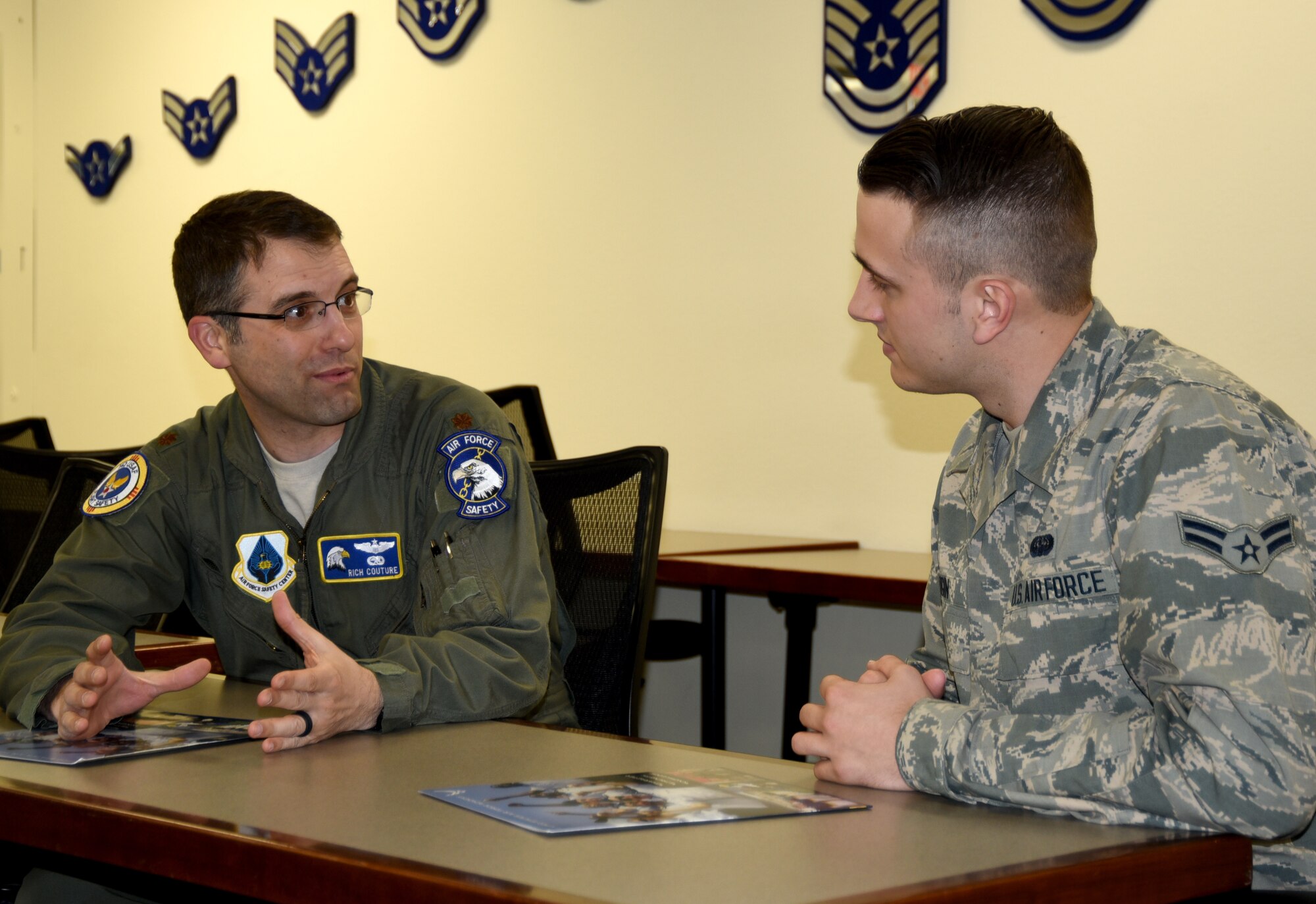 Maj. Rich Couture, an executive officer with the Air Force Safety Center, discusses the Air Force Academy with Airman 1st Class Gregory Ogin of the 58th Special Operations Wing.  Couture  serves as the AFA deputy admissions liaison officer for all of New Mexico and El Paso.