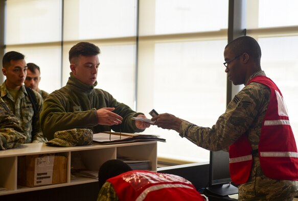 Airmen out-process through a deployment line at Ellsworth Air Force Base, S.D., April 2, 2018. The 28th Bomb Wing deployed B-1 bombers, Airmen and support equipment to Al Udied Air Base, Qatar, to fly missions in U.S. Central Command. (U.S. Air Force photo by Senior Airman Randahl J. Jenson)