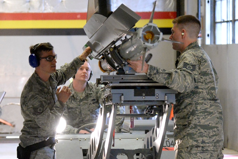 Tech. Sgt. Daniel Pas, Staff Sgt. Richard Shafer, and Staff Sgt. Elliot Berg represent the 419th Aircraft Maintenance Squadron during an F-35 weapons load competition