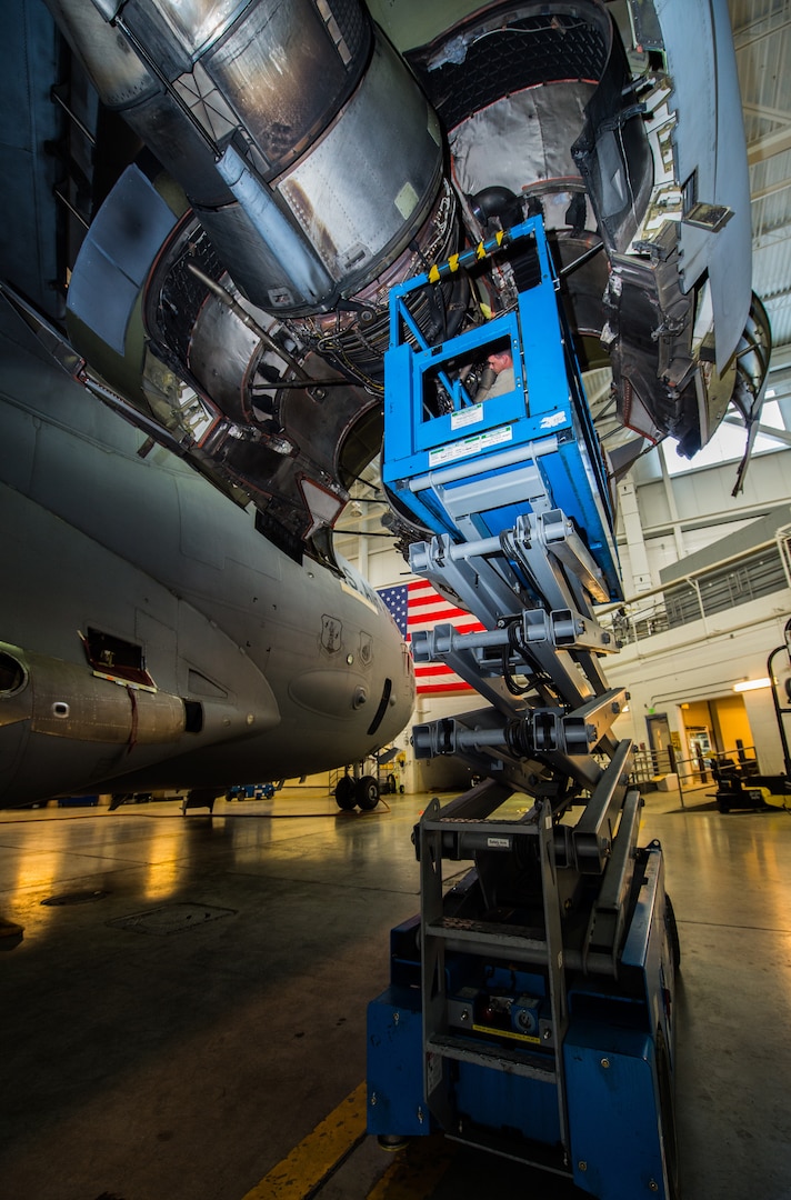 Senior Airman Austin Barbahm, 3rd Maintenance Squadron aerospace propulsion journeyman, and Airman 1st Class Adam Babcock, 3rd MXS aerospace propulsion apprentice, perform maintenance on a C-17 Globemaster III assigned to the 176th Wing during a home station check at Joint Base Elmendorf-Richardson, Alaska, March 27, 2018. The 3rd and 176th maintenance squadrons complete an in-depth, four-day scheduled inspection of a C-17 approximately every 180 days. A home station check is the behind-the-scenes maintenance that can prevent loss of life, lead to savings in time and money and keep the aircraft fit to fight.