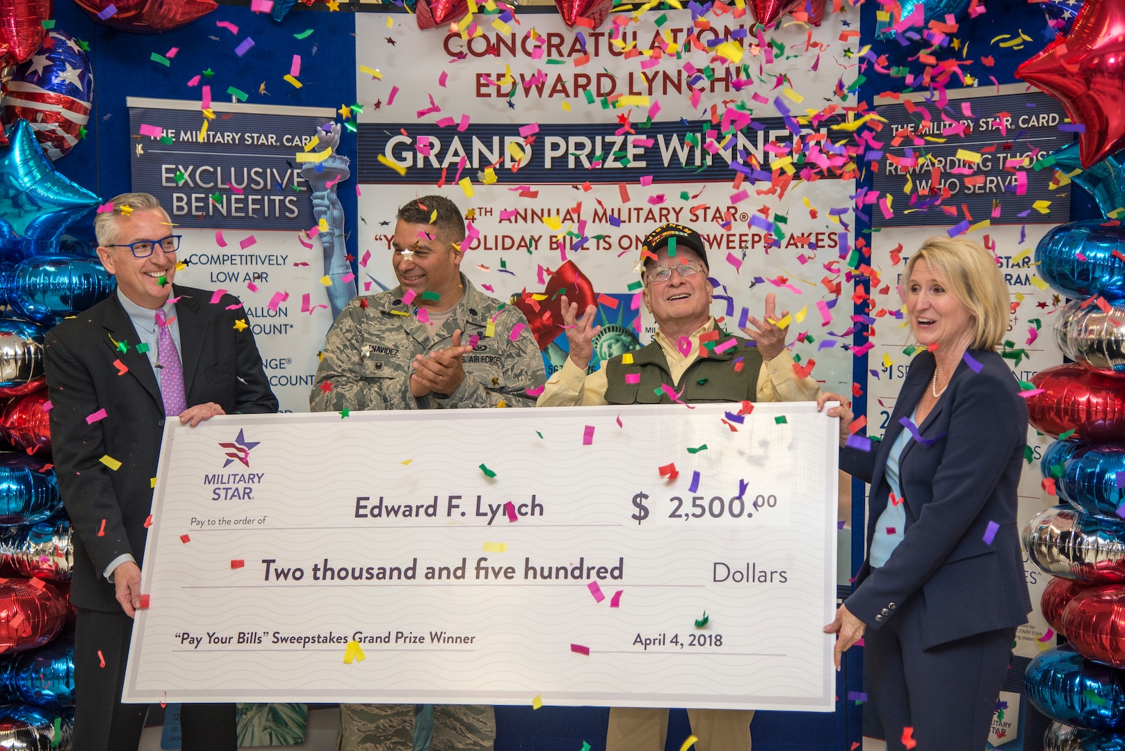 Retired Army Col. Edward Lynch (second from right) poses with (from left) James Jordan, Exchange chief financial officer; Lt. Col. Cas Benavidez, 502nd Force Support Group vice commander; and Jami Richardson, Exchange credit program senior vice president, after receiving a $2,500 check to pay off his Military Star card balance at the Joint Base San Antonio-Fort Sam Houston Exchange April 4. Lynch was entered into the contest when he used his card last fall to make a purchase.