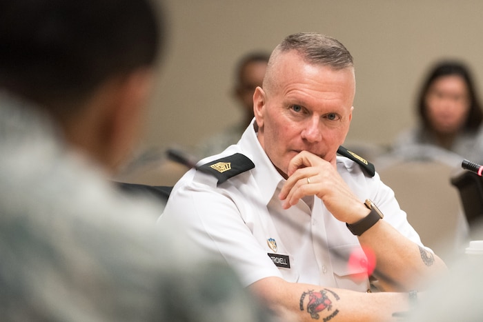 Army Command Sgt. Maj. John W. Troxell, senior enlisted advisor to the Chairman of the Joint Chiefs of Staff, sits in front of a microphone.