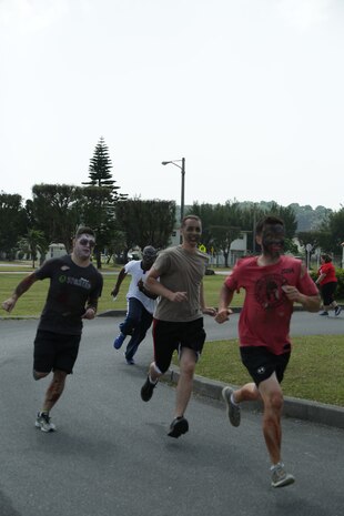 CAMP LESTER, OKINAWA, Japan – The zombie volunteers race after the runners during the American Red Cross hosted Zombie Race March 31 aboard Camp Lester, Okinawa, Japan.