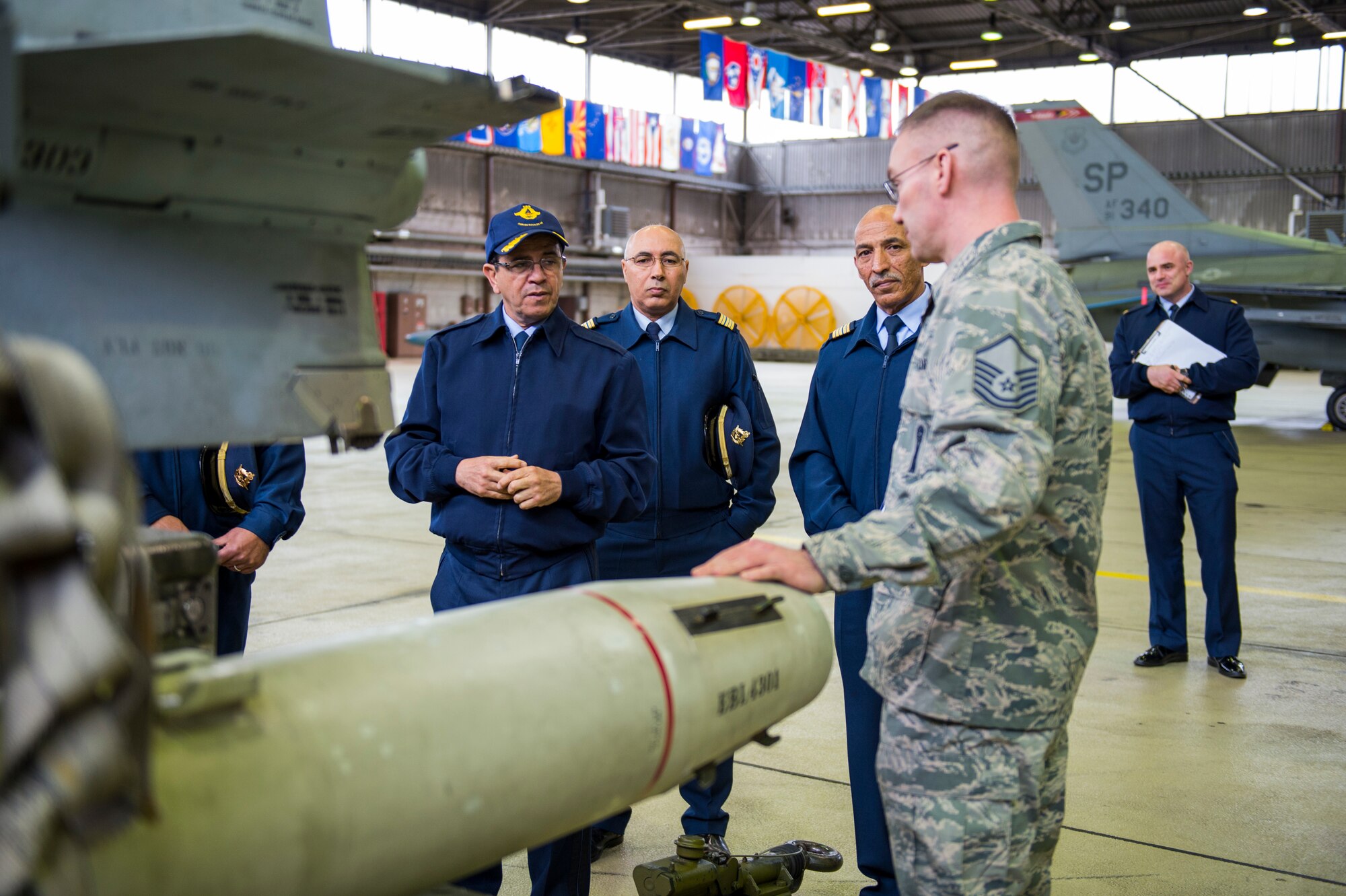 Maj. Gen. Hassan Fakri, Royal Moroccan Air Force deputy inspector, is given a tour by Master Sgt. Jason Tremmel, 52nd Maintenance Group load standardization crew team chief, of the various dummy weapons at Spangdahlem Air Base, Germany, March 28, 2018. Senior leaders from the RMAF spent time learning about the best practices of the 52nd MXG, Operations Group and the 480th Fighter Squadron. (U.S. Air Force photo by Senior Airman Dawn M. Weber)