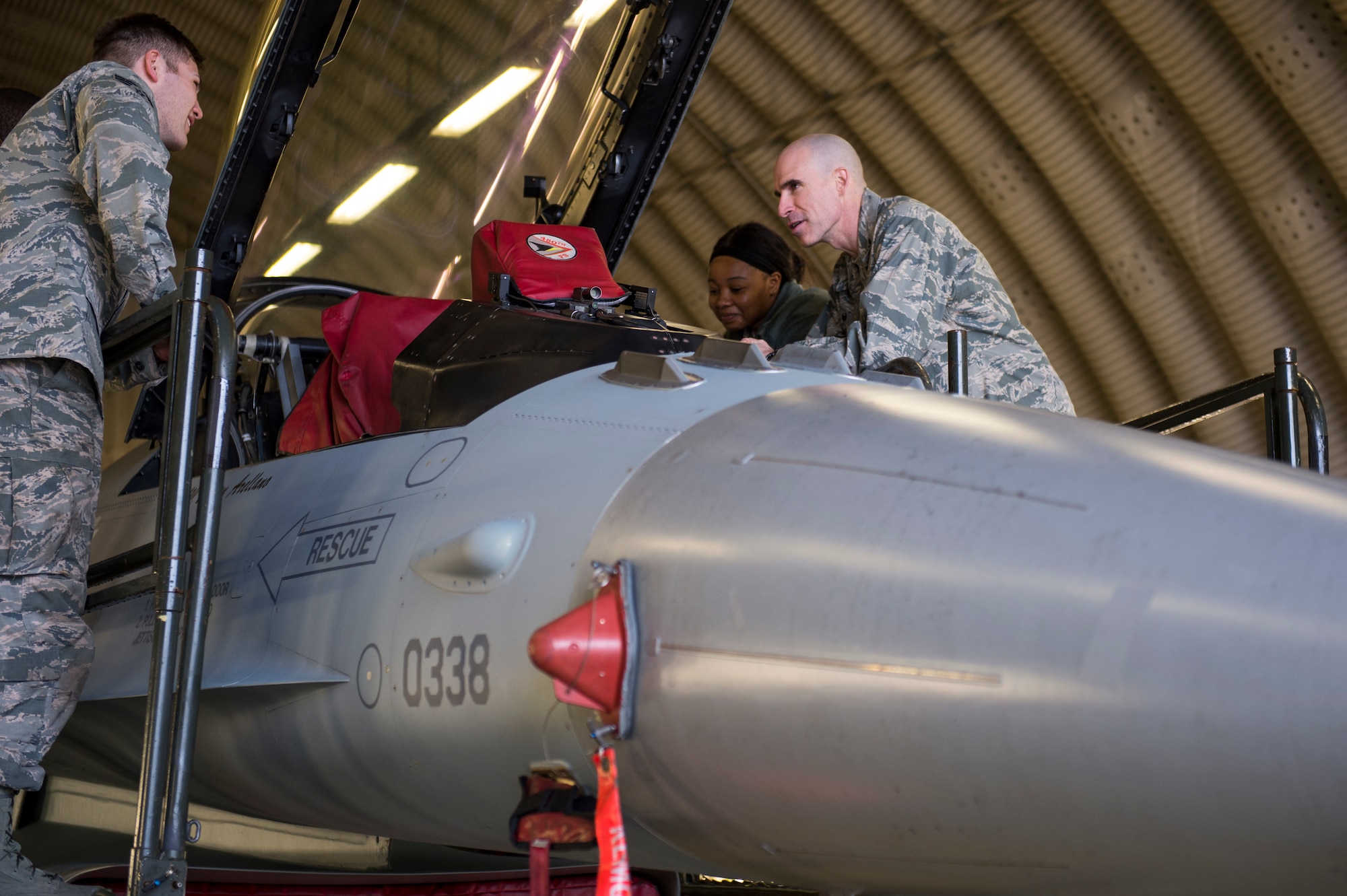 U.S. Air Force Col. Jason Bailey, 52nd Fighter Wing commander, explains the functions of an F-16 Fighting Falcon to Senior Airman Tyler MacMillan, (left), 52nd Logistics Readiness Squadron material handling equipment journeyman, and Airman 1st Class Leah Crawford, (right), 52nd LRS fleet management analyst journeyman, at Spangdahlem Air Base, Germany, April 4, 2018. The tour gave Airmen from around the 52nd FW the opportunity to meet the command team and expand their knowledge of flightline operations. (U.S. Air Force photo by Senior Airman Dawn M. Weber)