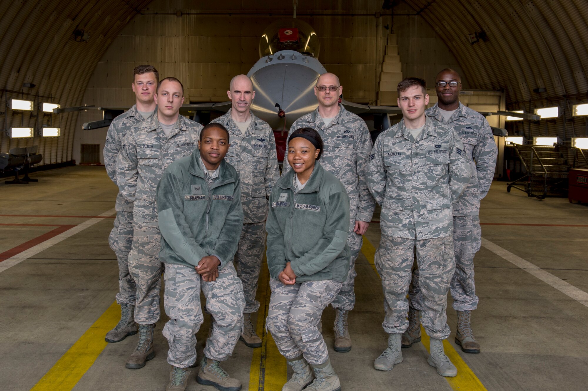 U.S. Air Force Col. Jason Bailey, 52nd Fighter Wing commander, and Chief Master Sgt. Christopher Vansile, 52nd FW acting command chief, pose with Airmen after a tour of an F-16 Fighting Falcon at Spangdahlem Air Base, Germany, April 4, 2018. The tour gave Airmen from around the 52nd FW an opportunity to meet the command team and expand their knowledge of flightline operations. (U.S. Air Force photo by Senior Airman Dawn M. Weber)