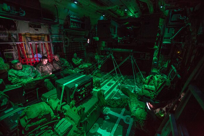 Marines from Kilo Battery, 2nd Battalion, 14th Marine Regiment, ride in an Air Force MC-130 after a live-fire mission with a Marine Corps M142 High Mobility Artillery Rocket System at Dugway Proving Grounds, Utah, March 30, 2018. Marines from Kilo Battery flew from Fort Campbell, Ky., to Dugway where they offloaded and fired four HIMARS missiles, demonstrating a unique capability that will give commanders more options to deal with threats when other options are not appropriate.