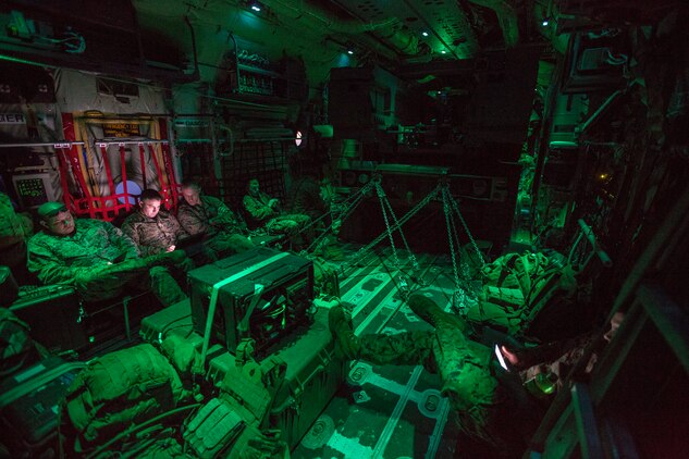 Marines from Kilo Battery, 2nd Battalion, 14th Marine Regiment, ride in an Air Force MC-130 after a live-fire mission with a Marine Corps M142 High Mobility Artillery Rocket System at Dugway Proving Grounds, Utah, March 30, 2018. Marines from Kilo Battery flew from Fort Campbell, Ky., to Dugway where they offloaded and fired four HIMARS missiles, demonstrating a unique capability that will give commanders more options to deal with threats when other options are not appropriate.