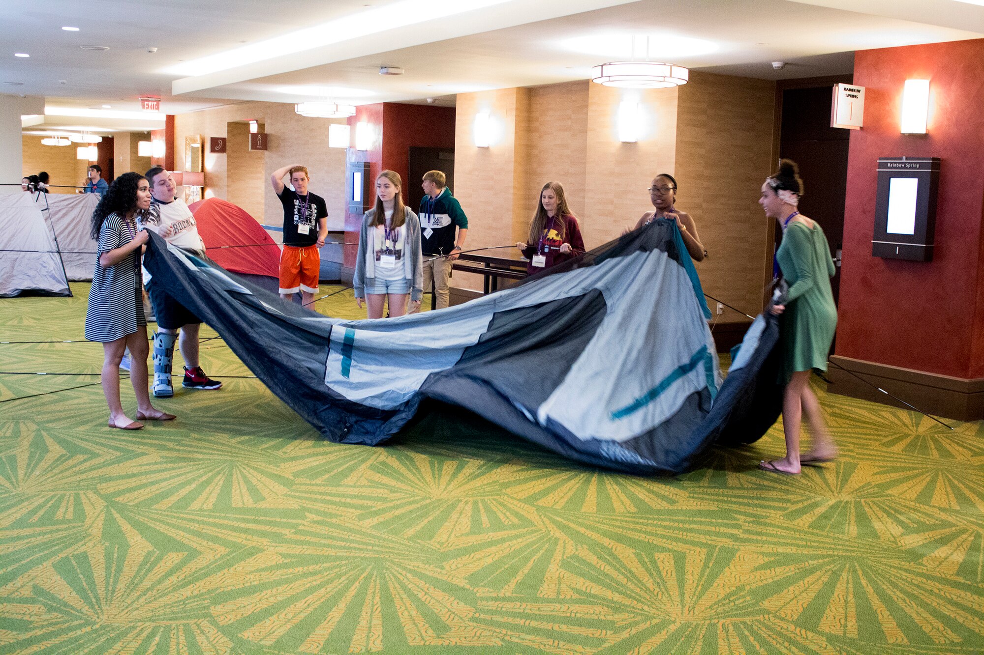 Teens of Reserve Citizen Airmen work together to pitch tents during a teamwork exercise at the Yellow Ribbon Reintegration Program event held March 16, 2018 in Orlando, Florida.