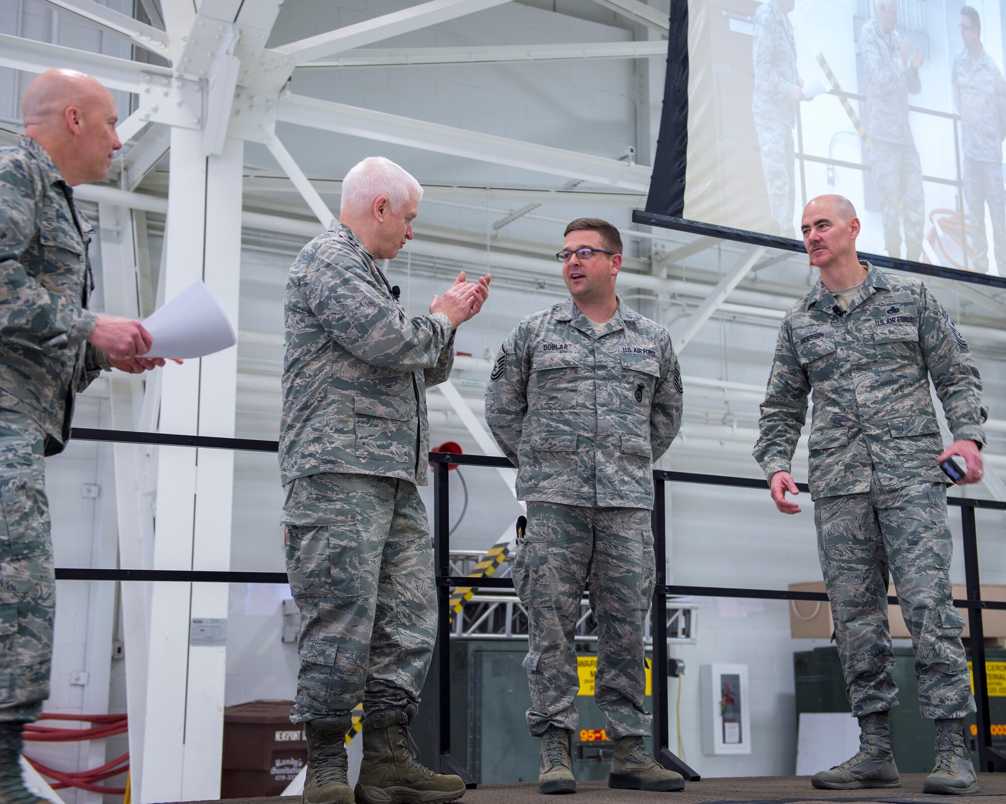 U.S. Air Force Master Sgt. Brian Doblar, 133rd Security Forces Squadron, receives a coin on behalf of Tech. Sgt. Brandon Peterson who was recognized and coined for his behind the scenes work with setting up weapons qualification and classroom instructions for the wing in St. Paul, Minn., March 25, 2018.