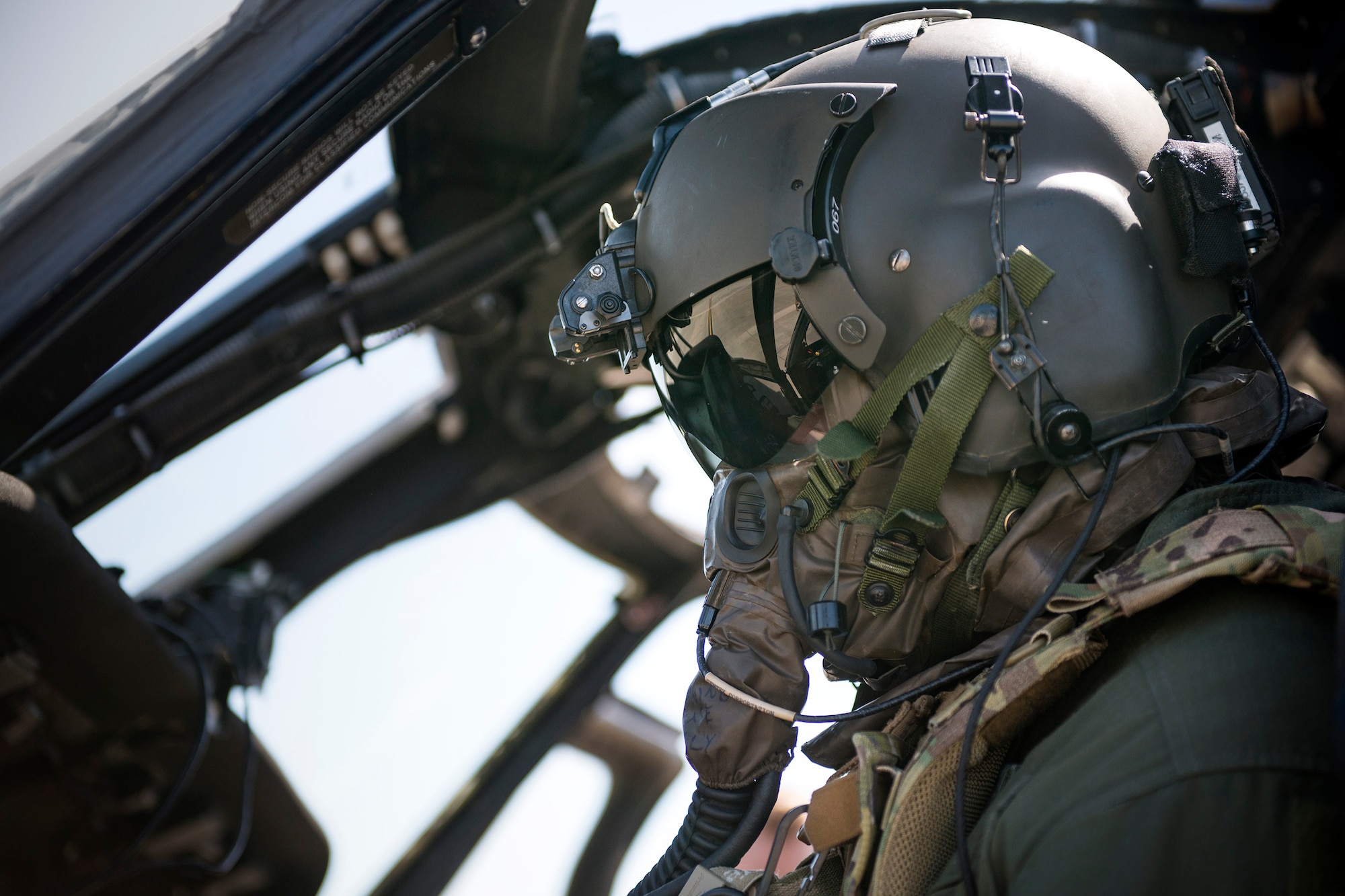 An HH-60G Pave Hawk pilot from the 41st Rescue Squadron performs post-flight operations during a chemical, biological, radiological and nuclear exercise, March 28, 2017, at Moody Air Force Base, Ga. The Airmen were geared up in mission-oriented protective posture (MOPP) gear to simulate potential conditions they could face while deployed in austere environments. While in MOPP gear, Airmen have to deal with claustrophobic conditions, impaired communication and battle the constant threat of heat exhaustion, while completing the mission. (U.S. Air Force photo by Airman 1st Class Erick Requadt)