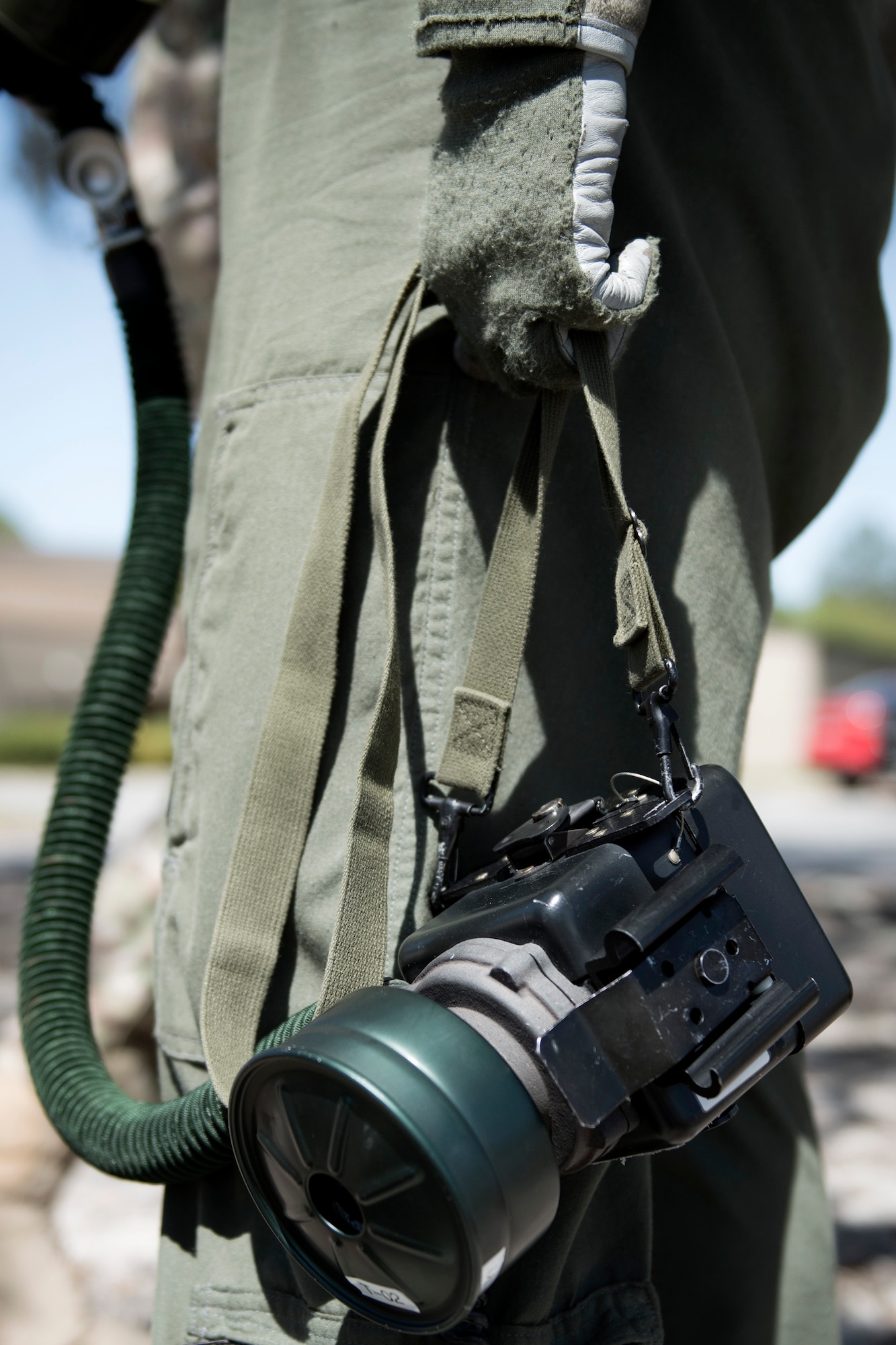 An HH-60G Pave Hawk crew member from the 41st Rescue Squadron holds his blower battery during a chemical, biological, radiological and nuclear exercise, March 28, 2017, at Moody Air Force Base, Ga. The Airmen were geared up in mission-oriented protective posture (MOPP) gear to simulate potential conditions they could face while deployed in austere environments. While in MOPP gear, Airmen have to deal with claustrophobic conditions, impaired communication and battle the constant threat of heat exhaustion, while completing the mission. (U.S. Air Force photo by Airman 1st Class Erick Requadt)