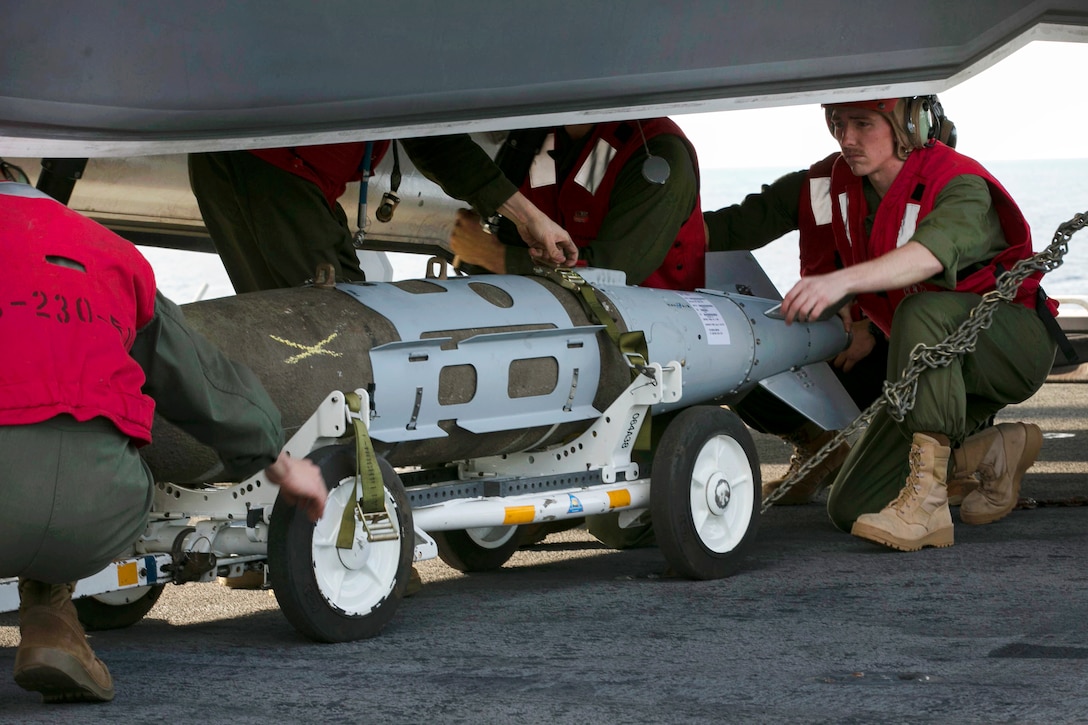 Marines align a 1,000-pound guided bomb.