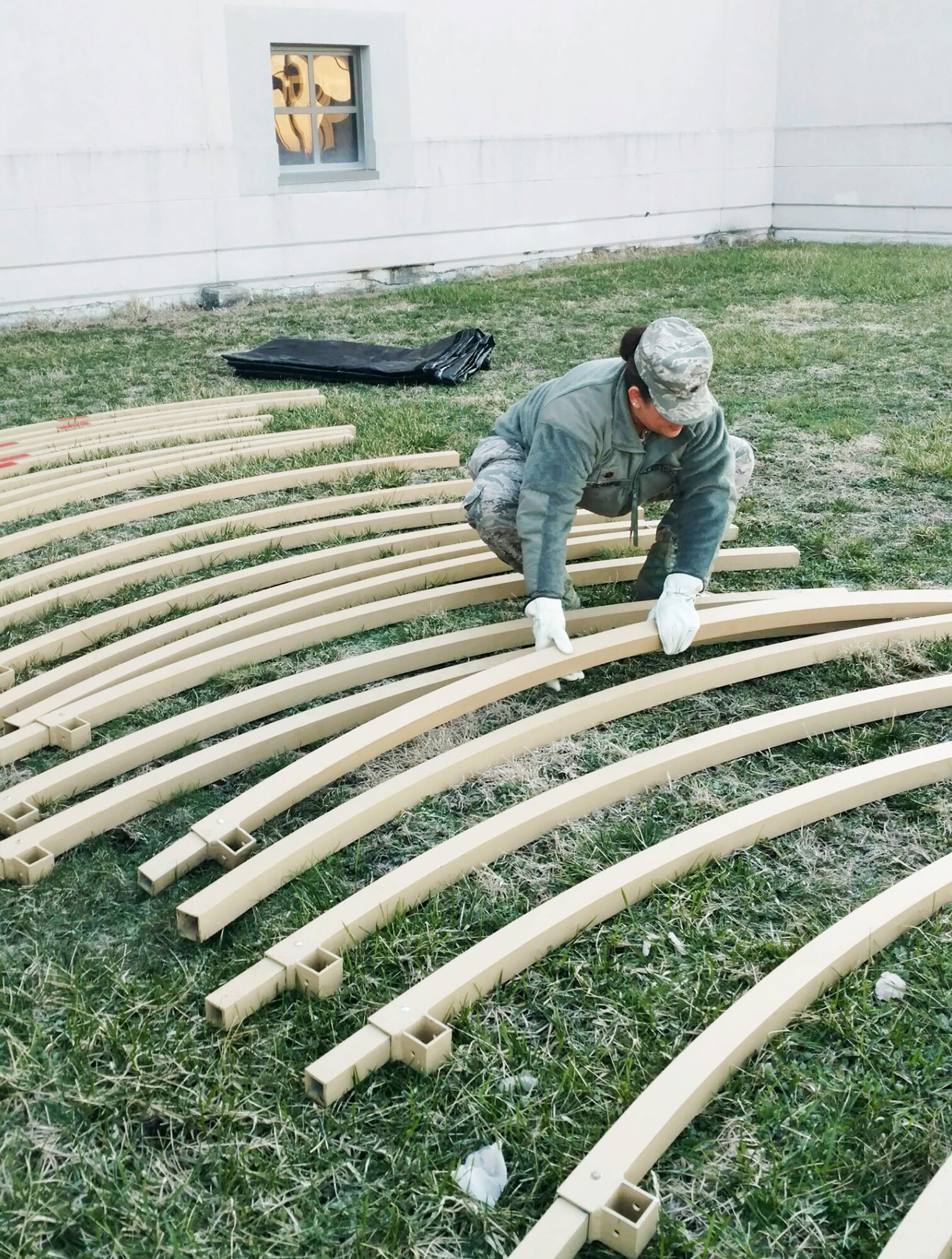 Maj. Sabrina Ocampo, 445th Force Support Squadron, organizes materials to be used to assemble a temporary lodging facility constructed during the March 4, 2018 unit training assembly at Wright-Patterson Air Force Base, Ohio.