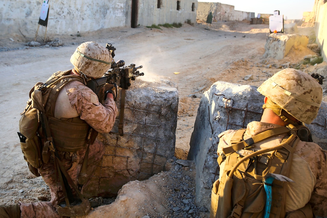 Marines fire their weapons at targets.