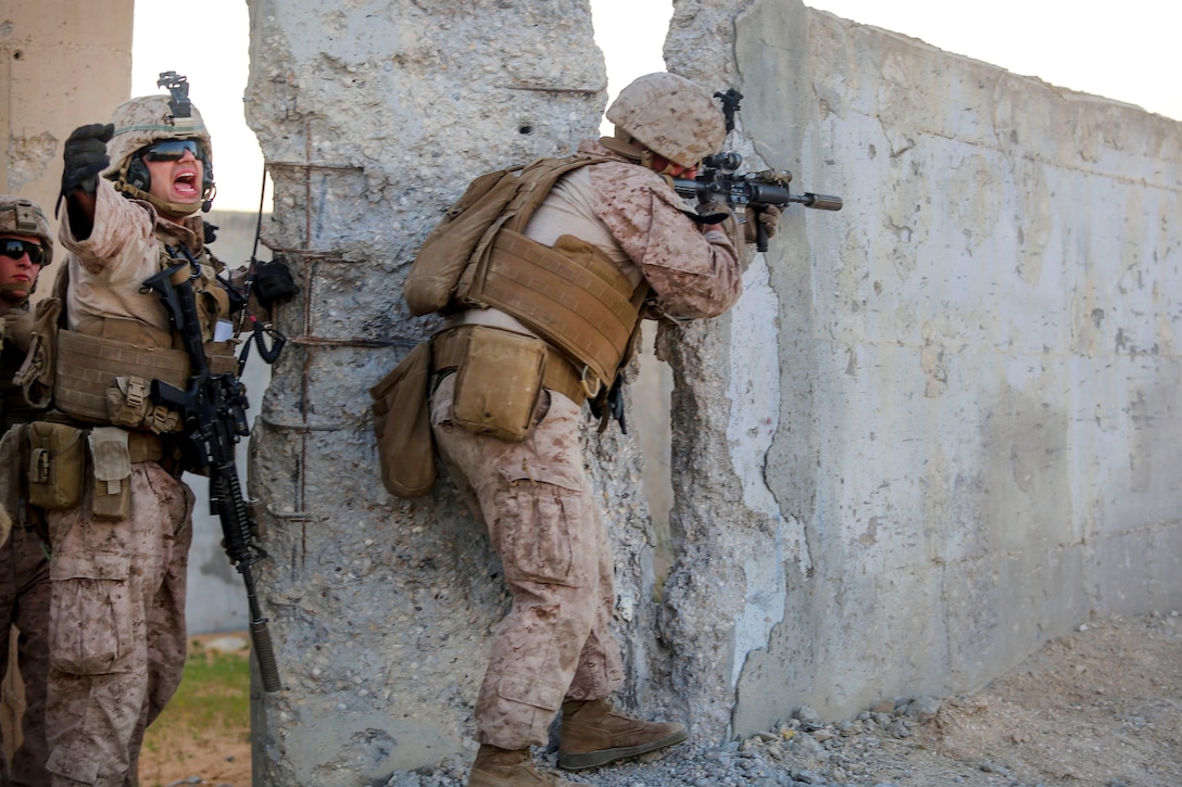 A Marine yells out orders to his team during a live-fire.