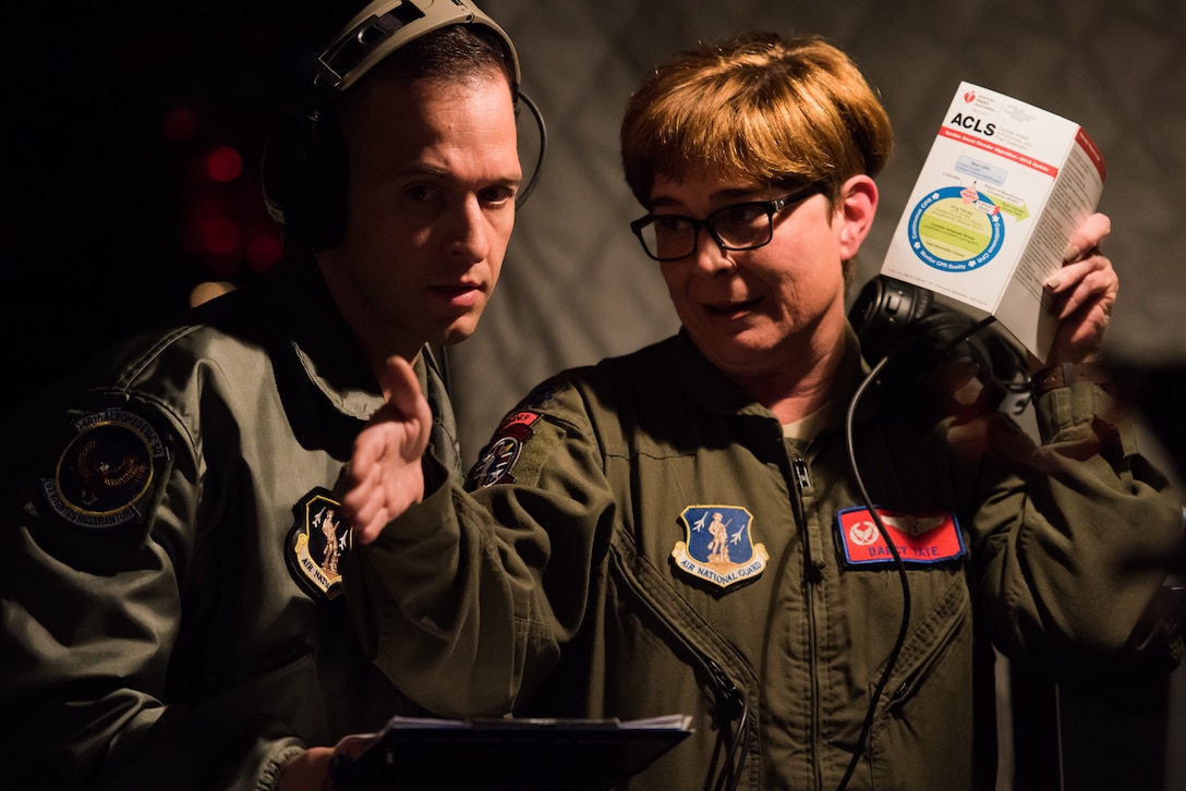 (From left) Senior Master Sgt. Eric Emmett, an aeromedical evacuation technician from the 146th Aeromedical Evacuation Squadron, California Air National Guard, talks with Lt. Col. Darcy Tate, an aeromedical evacuation evaluator from the 137 AES, Oklahoma ANG, during an in-flight training scenario on a KC-135 Stratotanker, March 27, 2018. The flight was a part of MATOP (Multiple Aircraft Training Opportunity Program), a hands-on training program organized by the 137th Aeromedical Evacuation Squadron at Will Rogers Air National Guard Base in Oklahoma City. It was designed to provide aeromedical evacuation squadrons from across the U.S. opportunities to work with the C-130 Hercules, KC-135 Stratotanker and C-17 Globemaster III. The flight brought together aeromedical evacuation units from California, West Virginia, North Carolina, Minnesota, Wyoming, Delaware, Mississippi, New York and Oklahoma. (U.S. Air National Guard photo by Staff Sgt. Tyler Woodward)