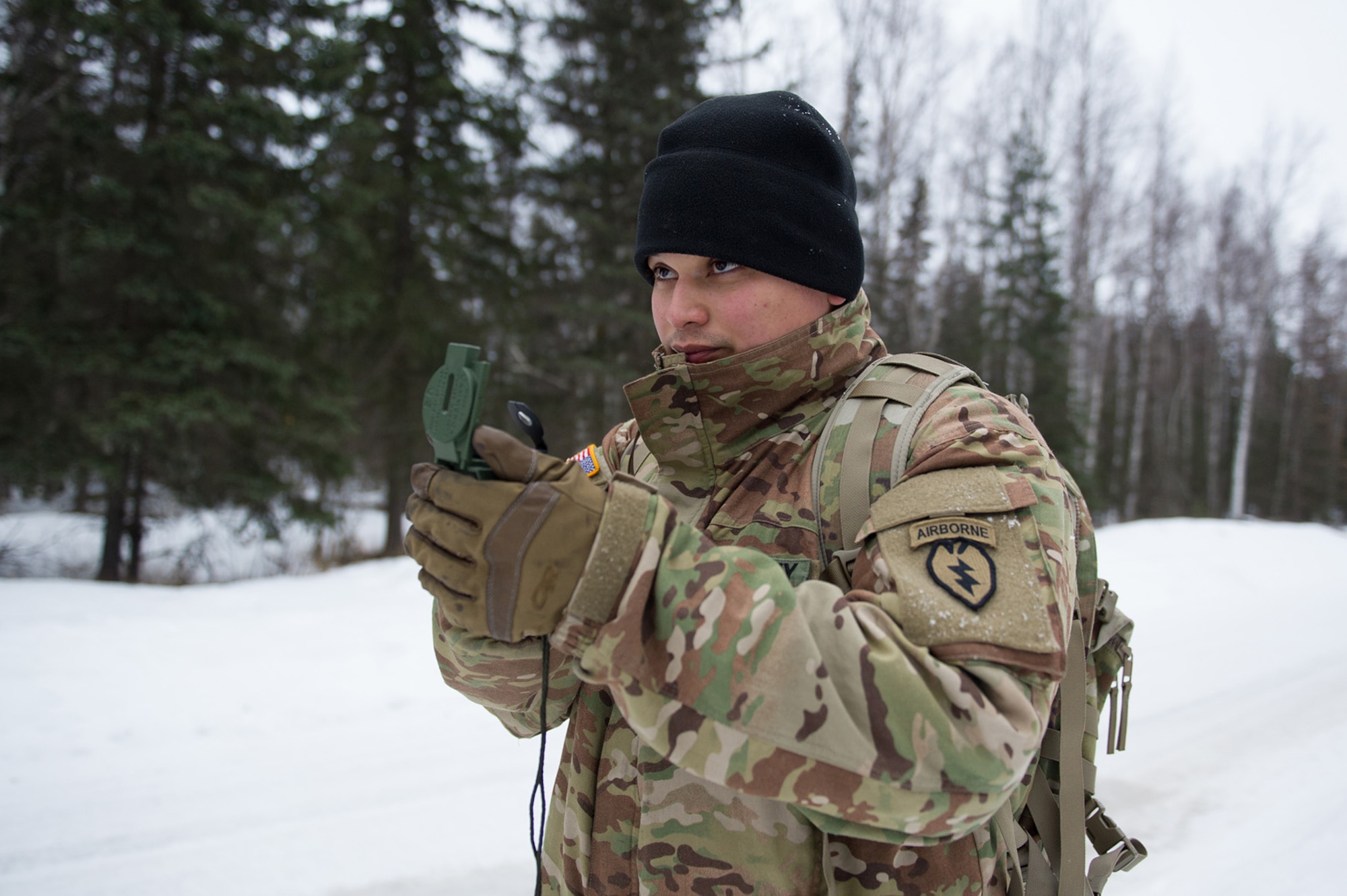 Army Sgt. Carlos Porras, a native of Burlington, NC, assigned to Hawk Company, 3rd Battalion, 509th Parachute Infantry Regiment, 4th Infantry Brigade Combat Team (Airborne), 25th Infantry Division, U.S. Army Alaska, shoots an azimuth with a compass during a land navigation course on Joint Base Elmendorf-Richardson, Alaska, April 4, 2018.  The Soldiers used their skills to plot courses using a lensatic compass, protractor, and a 1:25,000 scale map to navigate to, and locate points using provided grid coordinates within a predetermined time.