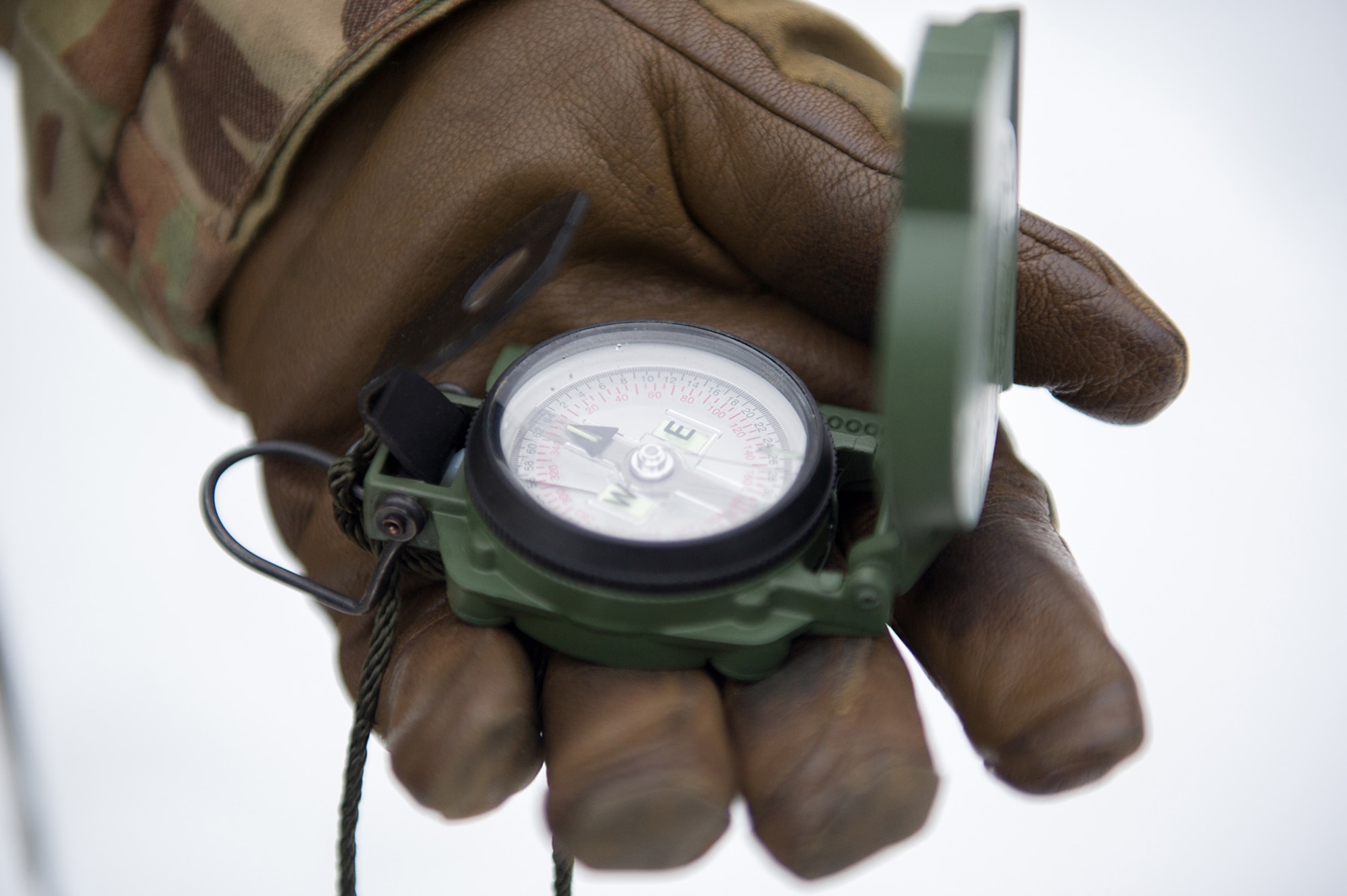 Army Sgt. Carlos Porras, a native of Burlington, NC, assigned to Hawk Company, 3rd Battalion, 509th Parachute Infantry Regiment, 4th Infantry Brigade Combat Team (Airborne), 25th Infantry Division, U.S. Army Alaska, holds a compass during a land navigation course on Joint Base Elmendorf-Richardson, Alaska, April 4, 2018.  The Soldiers used their skills to plot courses using a lensatic compass, protractor, and a 1:25,000 scale map to navigate to, and locate points using provided grid coordinates within a predetermined time.