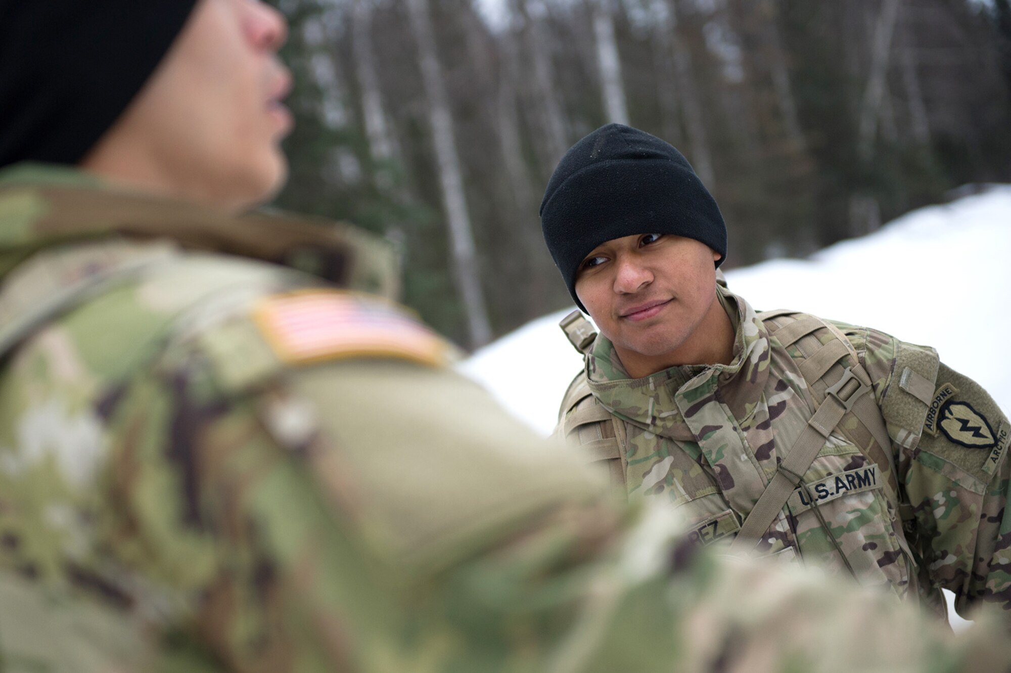 Army Sgt. Aldo Nevarez, a native of San Diego, Calif., assigned to Hawk Company, 4th Infantry Brigade Combat Team (Airborne), 25th Infantry Division, U.S. Army Alaska, listens to a fellow soldier while conducting a land navigation course on Joint Base Elmendorf-Richardson, Alaska, April 4, 2018.  The Soldiers used their skills to plot courses using a lensatic compass, protractor, and a 1:25,000 scale map to navigate to, and locate points using provided grid coordinates within a predetermined time.