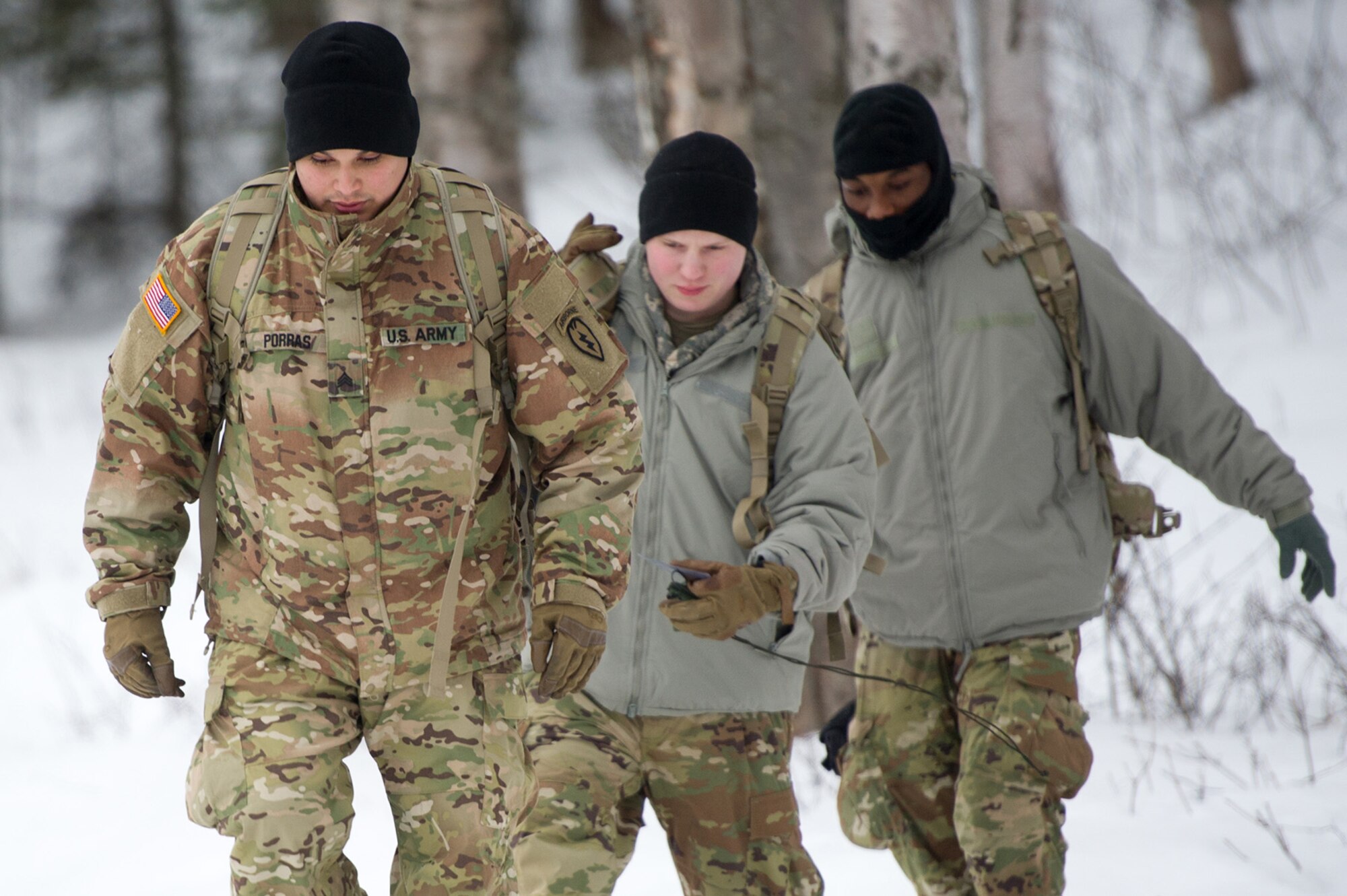 Army Sgt. Carlos Porras, a native of Burlington, NC, assigned to Hawk Company, 3rd Battalion, 509th Parachute Infantry Regiment, 4th Infantry Brigade Combat Team (Airborne), 25th Infantry Division, U.S. Army Alaska, leads Soldiers over an icy berm during a land navigation course on Joint Base Elmendorf-Richardson, Alaska, April 4, 2018.  The Soldiers used their skills to plot courses using a lensatic compass, protractor, and a 1:25,000 scale map to navigate to, and locate points using provided grid coordinates within a predetermined time.