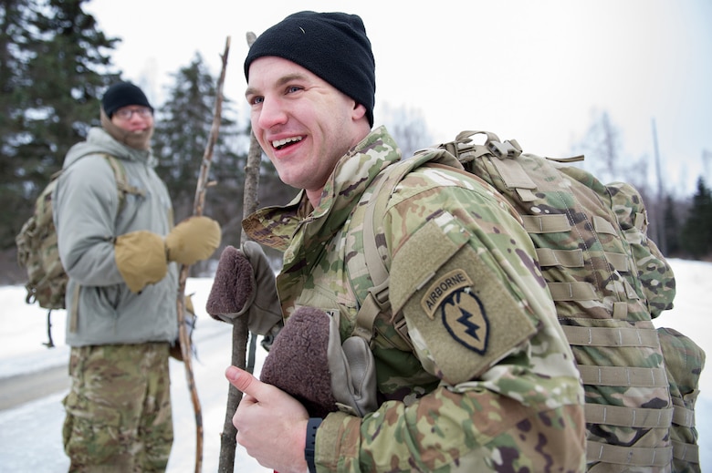 Spc. Matthew Linzer, Hampton, NJ, assigned to Hawk Company, 3rd Battalion, 509th Parachute Infantry Regiment, 4th Infantry Brigade Combat Team (Airborne), 25th Infantry Division, U.S. Army Alaska, pauses on a road during a land navigation course on Joint Base Elmendorf-Richardson, Alaska, April 4, 2018.  Linzer and fellow Soldiers used their skills to plot courses using a lensatic compass, protractor, and a 1:25,000 scale map to navigate to, and locate points using provided grid coordinates within a predetermined time.