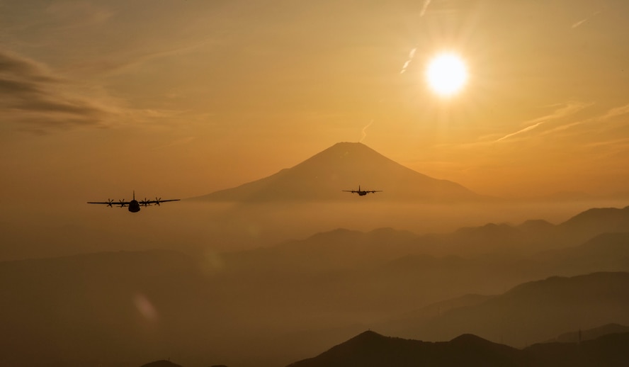 Two C-130J Super Hercules fly over Yamanashi Prefecture, Japan, after conducting airdrop training missions, March 26, 2018. The C-130J assigned to the 36th Airlift Squadron regularly conducts training missions to remain proficient in necessary skills to support any contingency. (U.S. Air Force photo by Yasuo Osakabe)