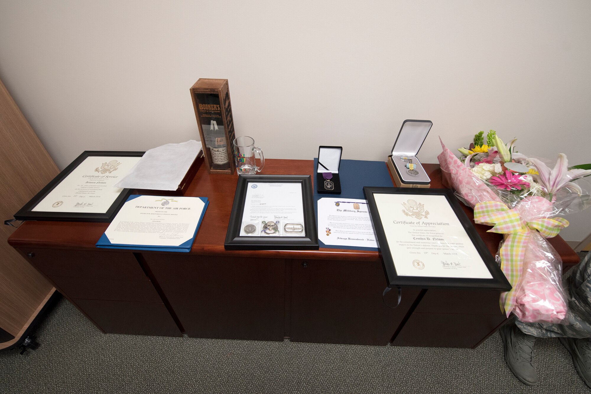 Certificates and commendation medals honoring Arlonzo Nelson, 23d Maintenance Group computer assistant, rest on a table during a retirement ceremony, March 29, 2018, at Moody Air Force Base, Ga. Nelson is retiring after 30 years of civilian service here. (U.S. Air Force photo by Airman Eugene Oliver)