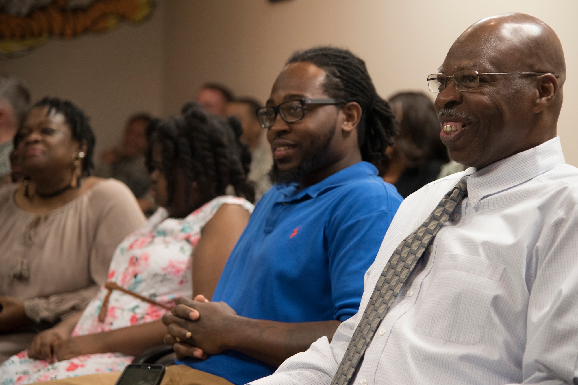 Arlonzo Nelson, 23d Maintenance Group computer assistant, right, smiles during his retirement ceremony, March 29, 2018, at Moody Air Force Base, Ga. Nelson is retiring after 30 years of civilian service here. (U.S. Air Force photo by Airman Eugene Oliver)