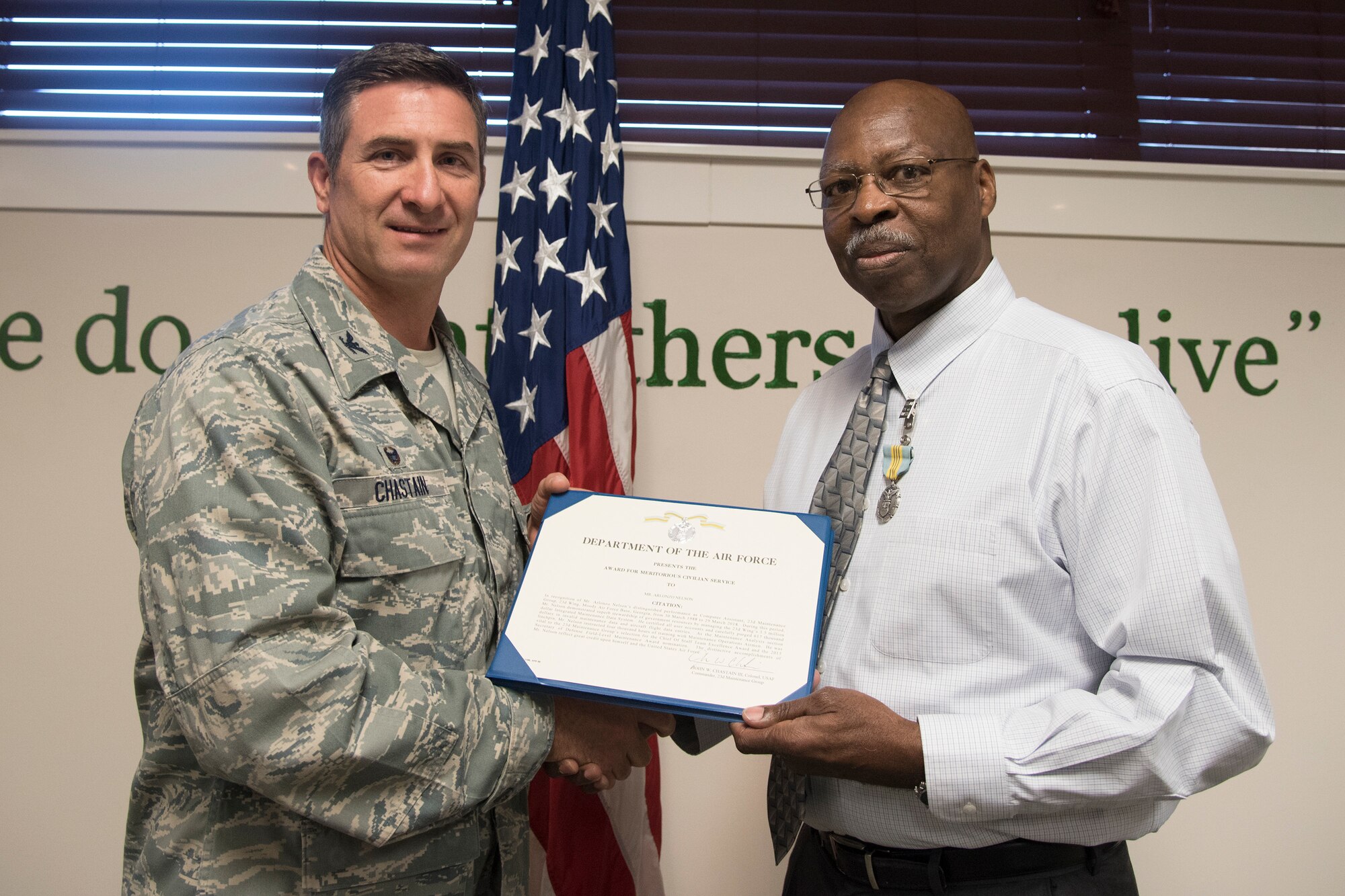Col. John Chastain, left, 23d Maintenance Group (MXG) commander and Arlonzo Nelson, 23d MXG computer assistant, pose for a photo at a retirement ceremony March 29, 2018, at Moody Air Force Base, Ga. Nelson is retiring after 30 years of civilian service here. (U.S. Air Force photo by Airman Eugene Oliver)