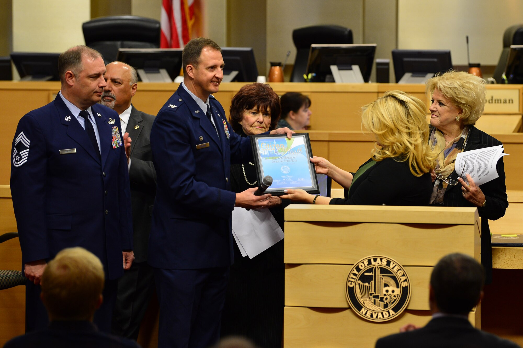 Col. Julian Cheater, 432nd Wing/432nd Air Expeditionary Wing commander and Chief Master Sgt. Jeffrey Taylor, 432nd WG/432nd AEW interim command chief accept the April Las Vegas Citizen of the Month award on behalf of the men and women of Creech Air Force Base at the Las Vegas City Hall, April 4, 2018. Alongside their dedication to the Remotely Piloted Aircraft enterprise, many Creech Airmen make an impact by volunteering at organizations throughout the Las Vegas community. (U.S. Air Force photo by Airman 1st Class Haley Stevens)