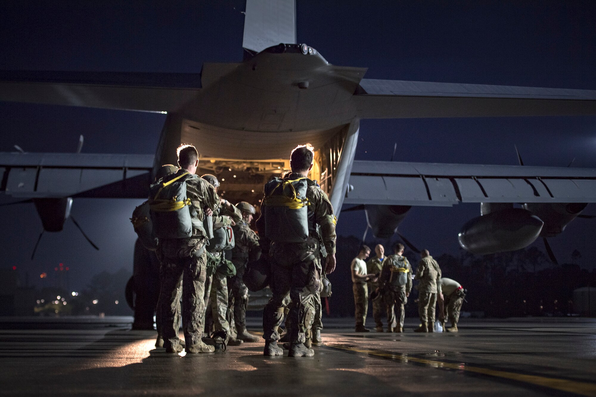 Airmen from the 820th Base Defense Group and the 71st Rescue Squadron prepare for a static-line jump proficiency training, March 30, 2018, at Moody Air Force Base, Ga. The 820th BDG and the 71st RQS work together frequently so the defenders and the aircrew can maintain their qualifications.  (U.S. Air Force photo by Staff Sgt. Ryan Callaghan)
