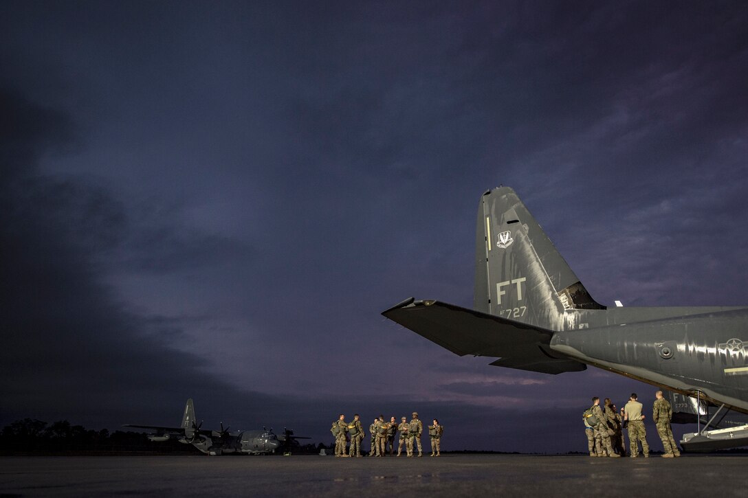Airmen from the 820th Base Defense Group and the 71st Rescue Squadron prepare for a static-line jump proficiency training, March 30, 2018, at Moody Air Force Base, Ga. The 820th BDG and the 71st RQS work together frequently so the defenders and the aircrew can maintain their qualifications. (U.S. Air Force photo by Staff Sgt. Ryan Callaghan)