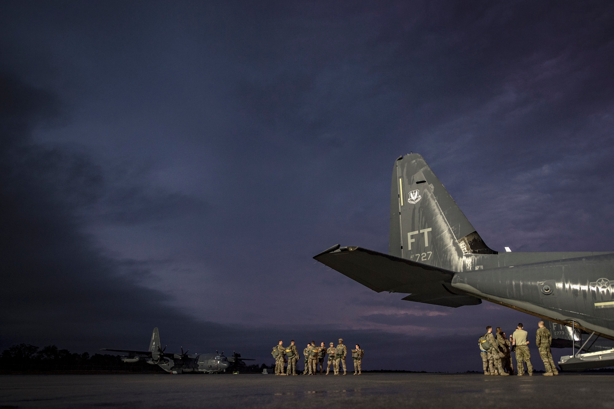 Airmen from the 820th Base Defense Group and the 71st Rescue Squadron prepare for a static-line jump proficiency training, March 30, 2018, at Moody Air Force Base, Ga. The 820th BDG and the 71st RQS work together frequently so the defenders and the aircrew can maintain their qualifications. (U.S. Air Force photo by Staff Sgt. Ryan Callaghan)