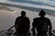 Staff Sgt. James Baker, left, and Master Sgt. Jeff Nieding, both 71st Rescue Squadron loadmasters, sit on the ramp in the rear of an HC-130J Combat King II, March 30, 2018, in the skies over Florida. As loadmasters, they are responsible for calculating aircraft weight and balance records, maintaining the cargo manifest, conducting cargo and personnel airdrops, and troubleshooting in-flight problems. (U.S. Air Force photo by Staff Sgt. Ryan Callaghan)