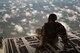 Staff Sgt. James Baker, 71st Rescue Squadron loadmaster, sits on the ramp in the rear of an HC-130J Combat King II, March 30, 2018, in the skies over Florida. As a loadmaster, Baker is responsible for calculating aircraft weight and balance records, maintaining the cargo manifest, conducting cargo and personnel airdrops, and troubleshooting in-flight problems. (U.S. Air Force photo by Staff Sgt. Ryan Callaghan)