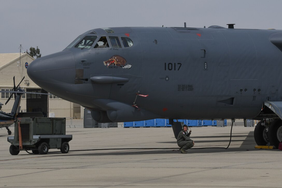 U.S. Air Force Senior Airman Jacob Lieuallen, a crewchief assigned to 2nd Aircraft Maintenance Squadron waits for a fuel truck to arrive to refuel B-52 Stratofrtress assigned to the 307th Bomb Wing, Barksdale Air Force Base, Louisiana, at March Air Reserve Station, California, April 5, 2018.
