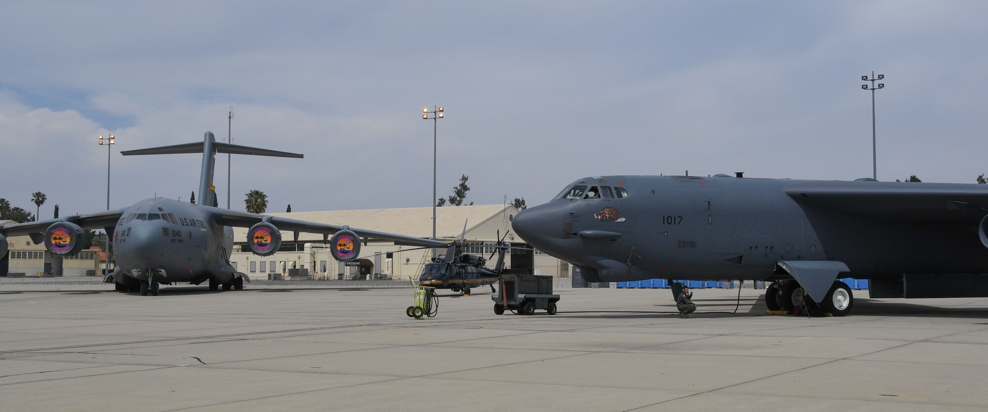 A B-52 Stratofrtress, assigned to the 307th Bomb Wing, Barksdale Air Force Base, Louisiana, sits next to a C-17 Globemaster III, assigned to the 452nd Air Refueling Wing, at March Air Reserve Base, California, April 5, 2018.