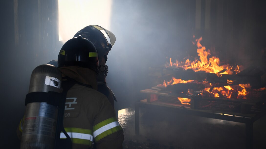 U.S. and Republic of Korea Air Force firefighters work together to put out a fire during a training exercise on Osan Air Base, Republic of Korea, March 26, 2018.